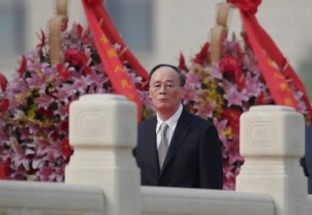 FILE PHOTO - China's Politburo Standing Committee member Wang Qishan, the head of China's anti-corruption watchdog, attends a tribute ceremony in front of the Monument to the People's Heroes at Tiananmen Square, ahead of National Day marking the 68th anniversary of the founding of the People's Republic of China in Beijing, China September 30, 2017. REUTERS/Jason Lee