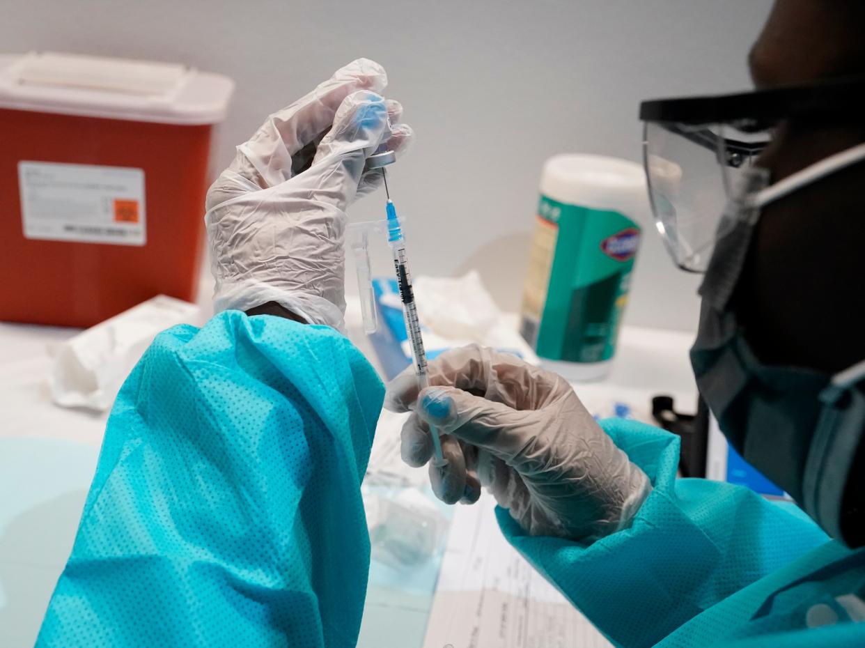 A health care worker fills a syringe with the Pfizer Covid-19 vaccine, Thursday, 22 July 2021 (AP)