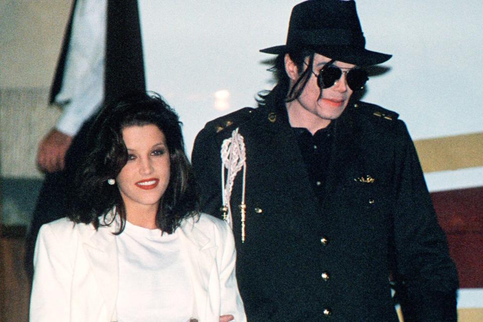 (FILES): This August 16, 1994 file photo shows US pop star Michael Jackson and his then wife Lisa-Marie Presley arriving at the airport in Budapest. Jackson died on June 25, 2009 after suffering a cardiac arrest, multiple US media outlets reported, sending shockwaves around the entertainment world. AFP PHOTO / Files (Photo credit should read -/AFP via Getty Images)