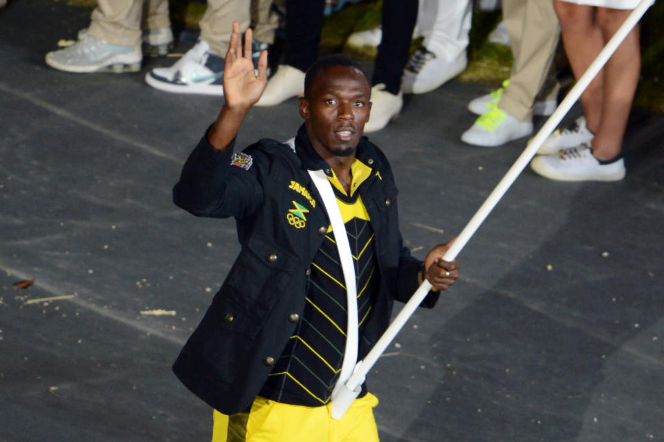 <b>Usain Bolt - 25</b><br>Reigning Olympic Men's 100m and 200m champion Usain Bolt of the Jamaica Olympic athletics team carries his country's flag during the Opening Ceremony of the London 2012 Olympic Games at the Olympic Stadium on July 27, 2012 in London, England. (Photo by Michael Regan/Getty Images)