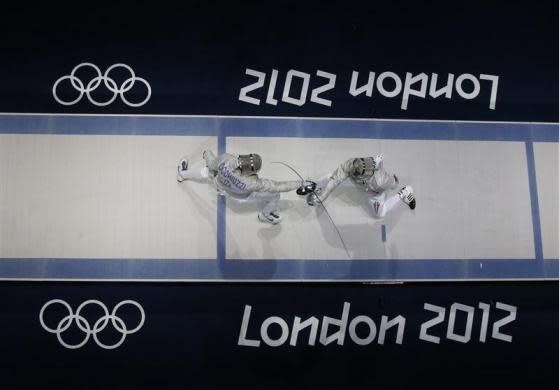 Hungary's Aron Szilagyi (R) competes against Italy's Diego Occhiuzzi during their men's sabre individual gold medal fencing match at the ExCel venue at the London 2012 Olympic Games July 29, 2012.