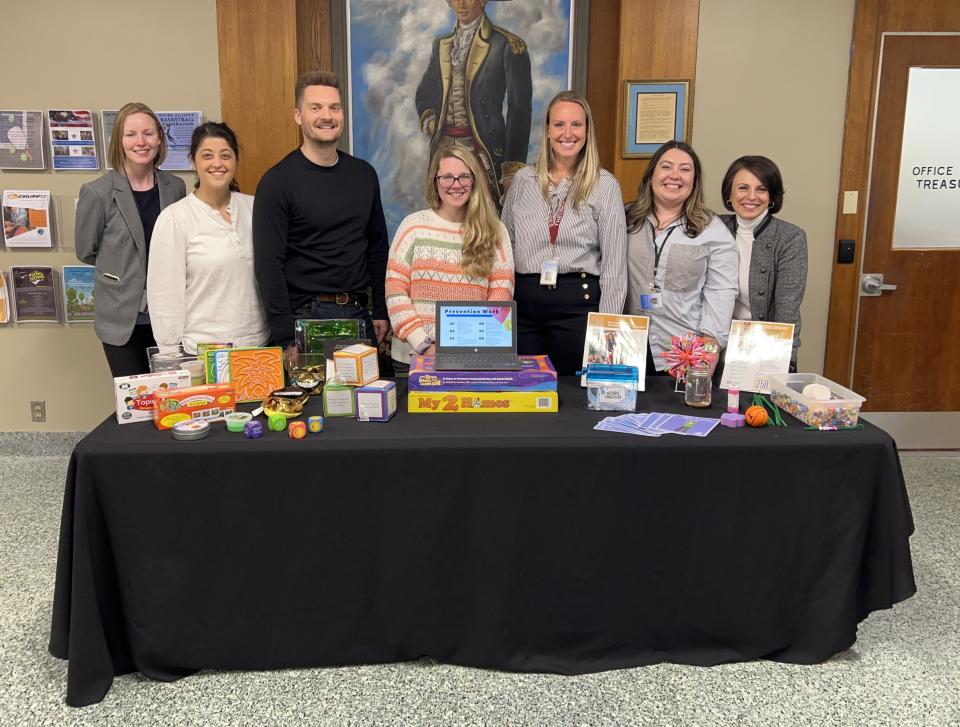 Jennifer Montana, far left, the supervisor of health and wellness for the Wayne K-12 district, and school counselors at a showcase of their work in the lobby of the municipal building on Valley Road on April 18.