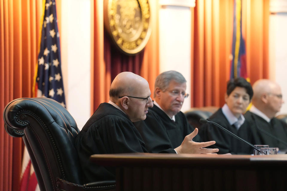 Colorado Supreme Court Justice Carlos Samour, Jr., left, asks a question during oral arguments before the court on Wednesday, Dec. 6, 2023, in Denver. Looking on are justices Richard L. Gabriel, second from left, Monica M. Marquez, third from left, and Chief Justice Brian D. Boatright. Colorado Supreme Court justices have sharply questioned whether they could exclude former President Donald Trump from the state's 2024 ballot. (AP Photo/David Zalubowski, Pool)