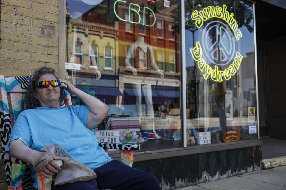 Robin Mitchell sitting outside a business speaks about the upcoming election Wednesday, June 19, 2024, in Racine, Wis. (AP Photo/Jeffrey Phelps)