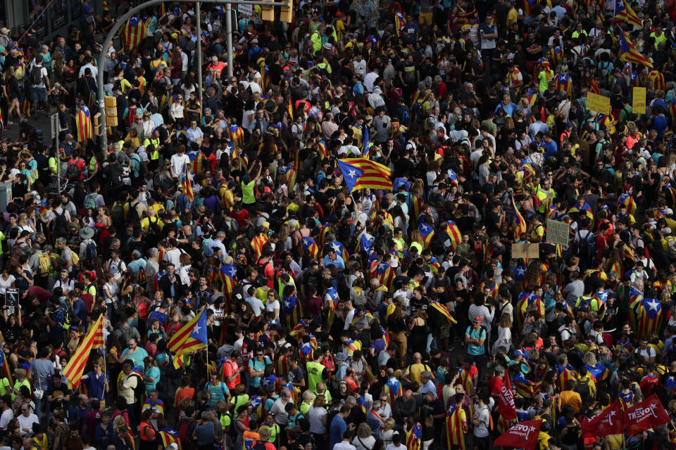 Protesters pack the street on the fifth day of protests over the conviction of a dozen Catalan independence leaders in Barcelona, Spain, Friday, Oct. 18, 2019. Tens of thousands of flag-waving demonstrators demanding Catalonia's independence and the release from prison of their separatist leaders have flooded downtown Barcelona. The protesters have poured into the city after some of them walked for three days in "Freedom marches" from towns across the northeastern Spanish region, joining students and workers who have also taken to the streets on a general strike day. (AP Photo/Manu Fernandez)