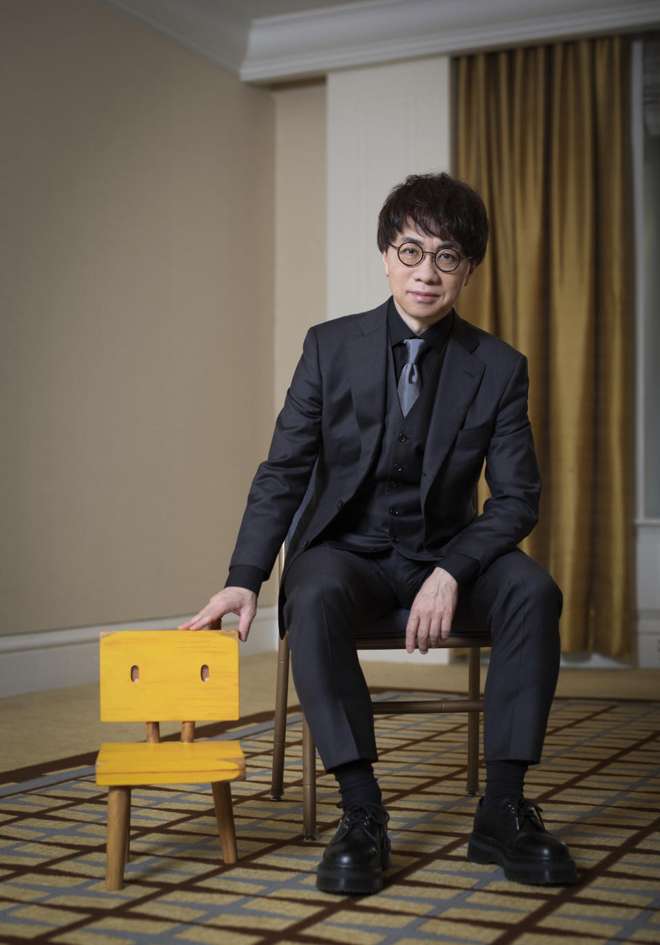 Makoto Shinkai poses for a portrait to promote the film "Suzume" on Tuesday, March 28, 2023 in New York. Shinkai was never the same filmmaker after the 2011 earthquake stuck Japan. His top three films since – "Your Name," "Weathering With You" and the new release "Suzume" -- have each tethered hugely emotional tales to ecological disaster. And they account for some of the biggest anime hits of all time. "Suzume" has already grossed more than $200 million. (Photo by Matt Licari/Invision/AP)