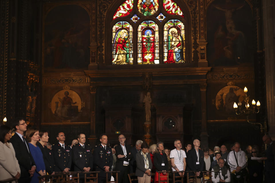 Faithfuls attend a Sunday Mass at the grandiose Saint-Eustache church on the Right Bank of the Seine river in Paris, Sunday, April 21, 2019. The archbishop of Paris and Catholics from around France and the world honored the firefighters who saved Notre Dame Cathedral, praying Sunday at a special Easter Mass for a swift reconstruction of the beloved monument. (AP Photo/Francisco Seco)