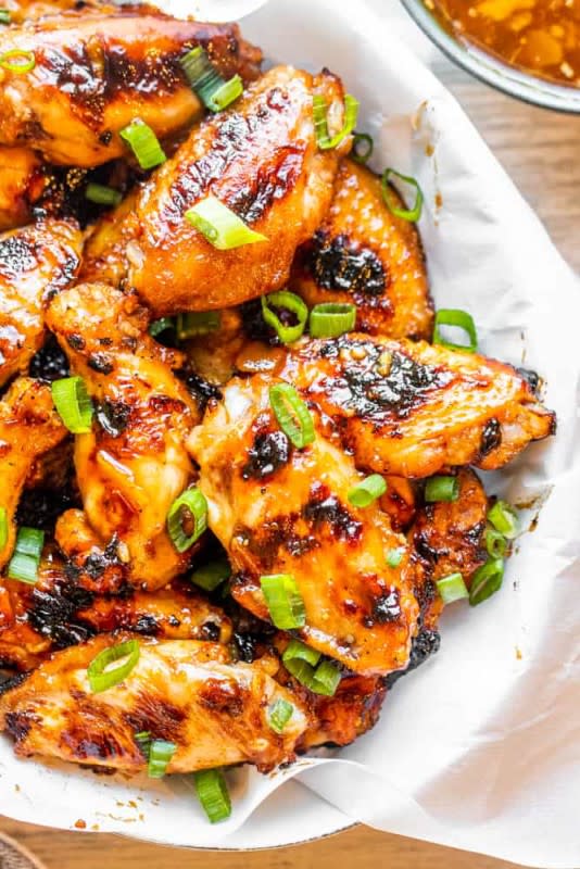 <p>This BBQ Peach Grilled Chicken Wings recipe is sweet, a bit spicy and smokey for a delicious flavor combination. <strong>Get the Recipe: <a href="https://erhardtseat.com/grilled-chicken-wings-recipe/" rel="nofollow noopener" target="_blank" data-ylk="slk:BBQ Peach Grilled Chicken Wings;elm:context_link;itc:0;sec:content-canvas" class="link ">BBQ Peach Grilled Chicken Wings</a></strong></p>