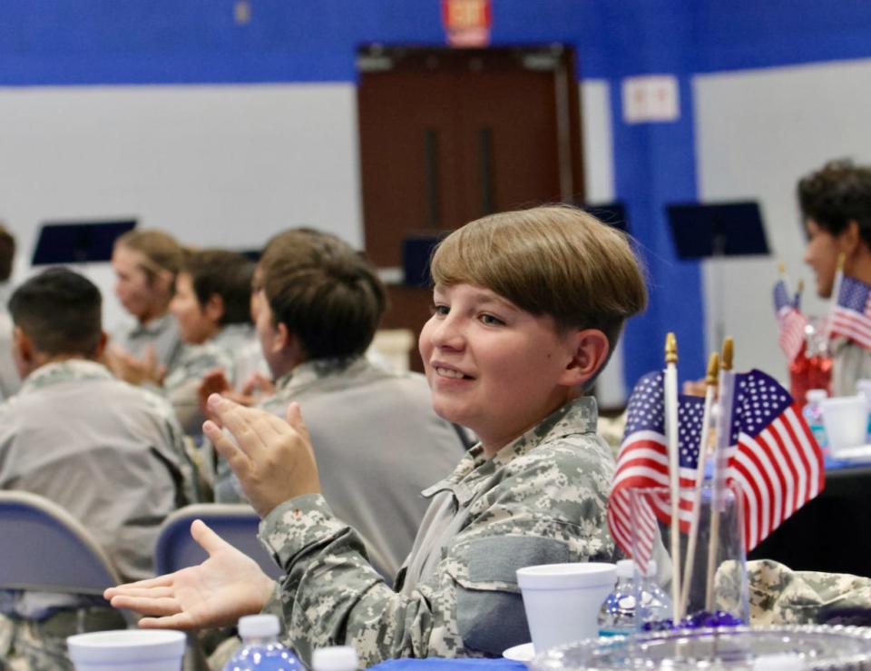 A Lucerne Valley Unified School District Ranger Cadet applauds during a ceremony where the district recognized a group of its employees who served in the U.S. military.
