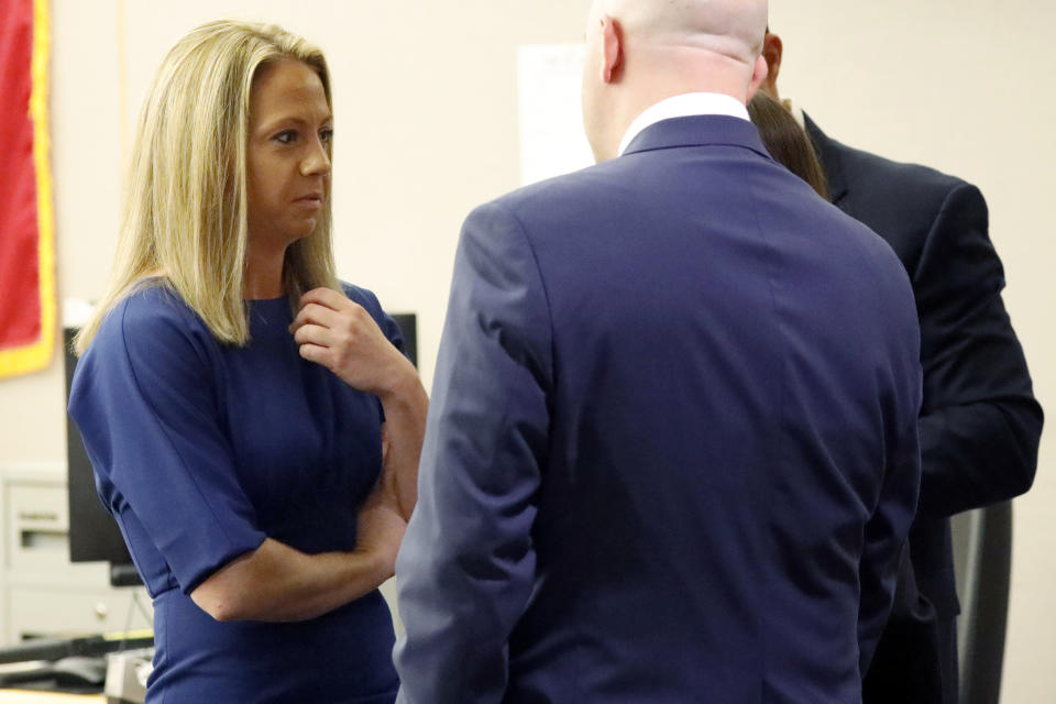 Former Dallas police Officer Amber Guyger speaks with her attorneys during a pretrial hearing in Judge Tammy Kemp's 204th District Court in Dallas, Monday, Sept. 23, 2019. Guyger is accused of shooting her black neighbor in his Dallas apartment. (Tom Fox/The Dallas Morning News via AP, Pool)