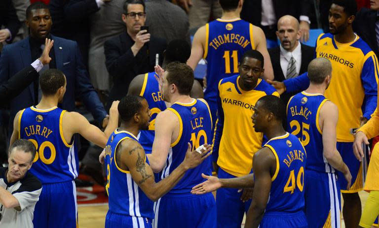 Players from the Golden State Warriors celebrate victory at the final whistle over the Los Angeles Clippers in Los Angeles, California on April 19, 2014