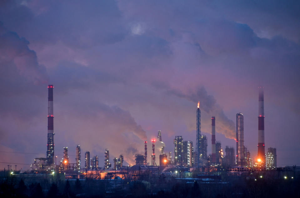 Flue gas and steam rise out of chimneys and smokestacks of an oil refinery during sunset on a frosty day in the Siberian city of Omsk, Russia, February 8, 2023. REUTERS/Alexey Malgavko