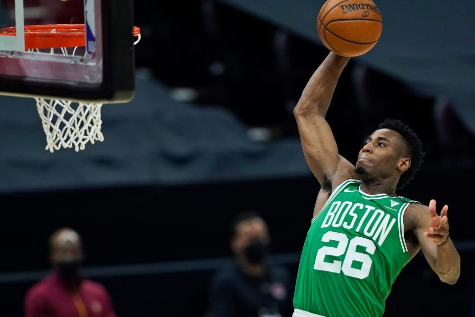Boston Celtics' Aaron Nesmith goes up for a dunk during the first half of the team's NBA basketball game against the Cleveland Cavaliers, Wednesday, May 12, 2021, in Cleveland. (AP Photo/Tony Dejak)
