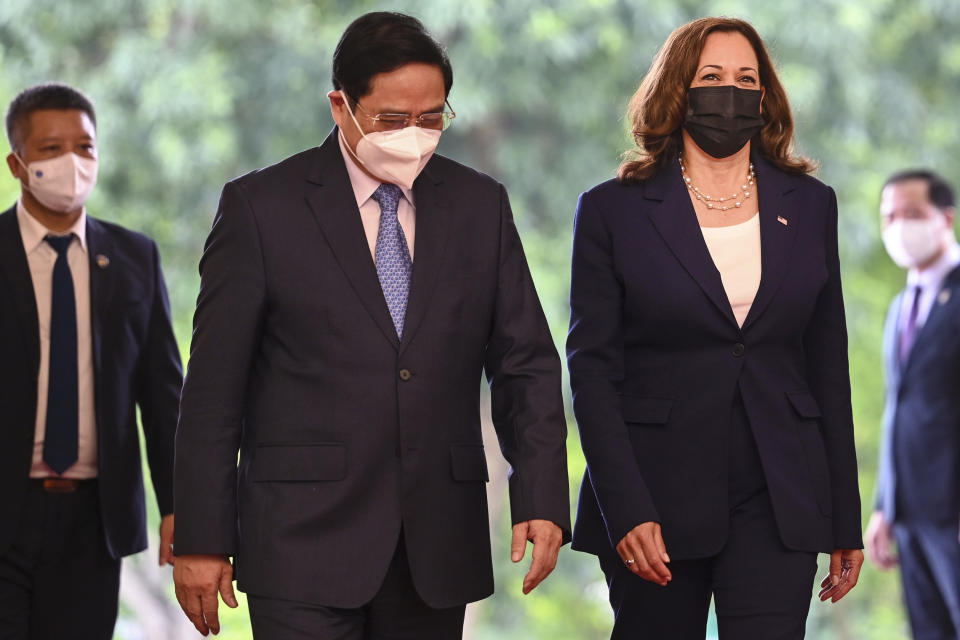 U.S. Vice President Kamala Harris, third from left, walks with Vietnamese Prime Minister Pham Minh Chinh at the government office in Hanoi, Vietnam, Wednesday, Aug. 25, 2021. Harris turns her focus to the coronavirus pandemic and global health during her visit to Vietnam, a country grappling with a worsening surge in the virus and stubbornly low vaccination rates. (Manan Vatsyayana/Pool Photo via AP)