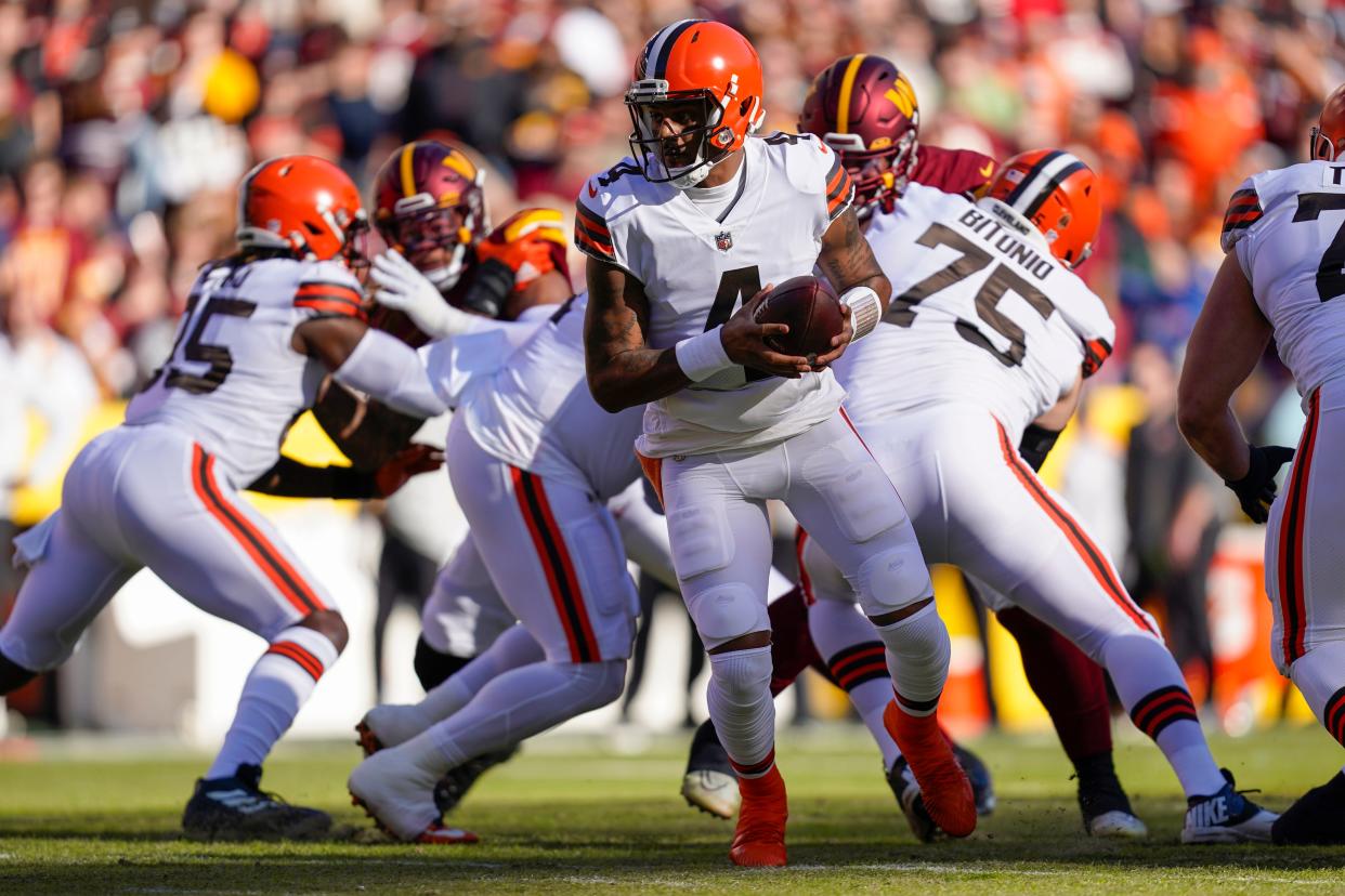Cleveland Browns quarterback Deshaun Watson (4) hands off the ball during the first half of an NFL football game against the Washington Commanders, Sunday, Jan. 1, 2023, in Landover, Md. (AP Photo/Patrick Semansky)