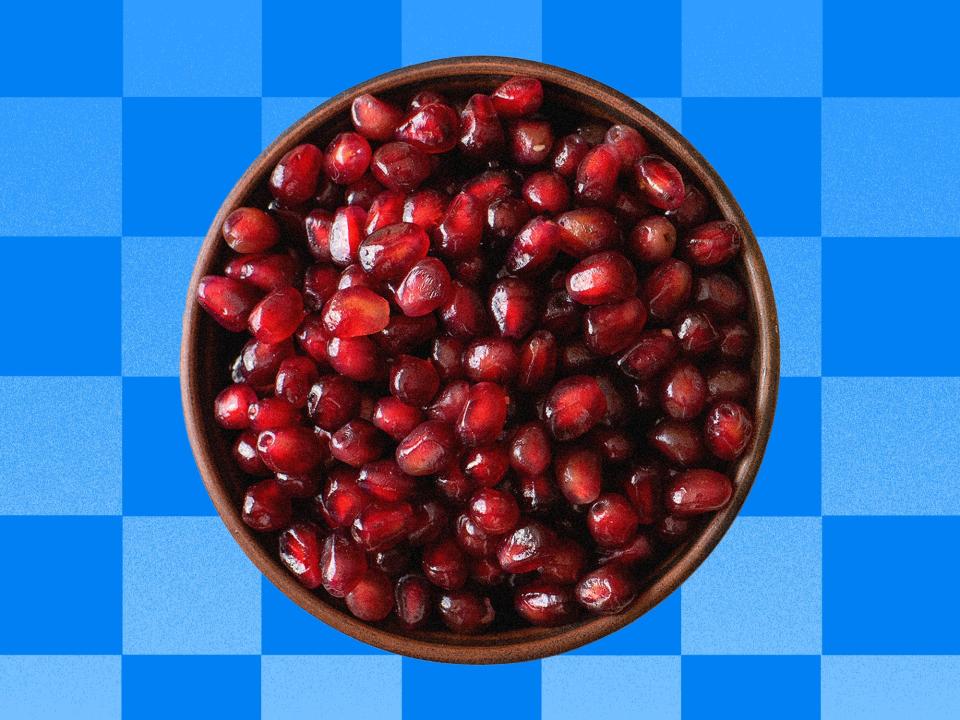 Pomegranate arils in front of a blue checkered backgground