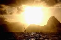 <p>An RS-X athlete is seen on the way back to the marina after the conclusion of racing on Day 7 of the Rio 2016 Olympic Games at Marina da Gloria on August 12, 2016 in Rio de Janeiro, Brazil. (Photo by Clive Mason/Getty Images) </p>