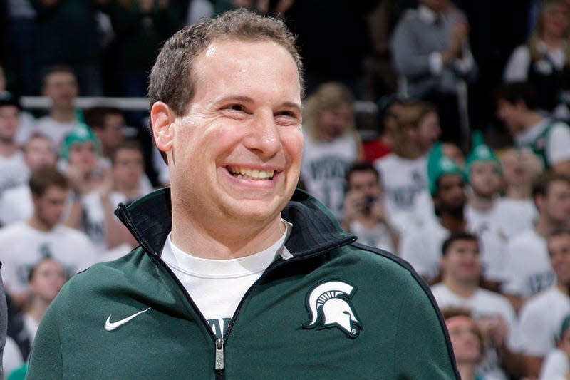 Former Michigan State player Mat Ishbia laughs as he are introduced along with Michigan State’s 2000 national championship NCAA college basketball team during halftime of the Michigan State-Florida game in East Lansing, Mich. Mortgage executive Mat Ishbia has agreed in principle to buy the Phoenix Suns and Phoenix Mercury from the embattled owner Robert Sarver for $4 billion, a person with knowledge of the negotiations told The Associated Press on Tuesday, Dec. 20, 2022.
