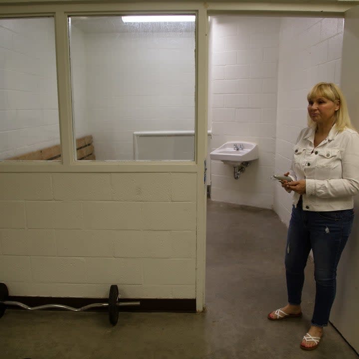 Lent stands in front of an open cell