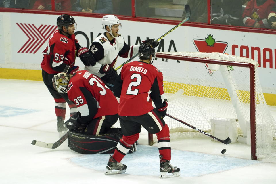 Arizona Coyotes defenseman Jordan Oesterle (82) scores on Ottawa Senators goaltender Marcus Hogberg (35) during third-period NHL hockey game action in Ottawa, Ontario, Thursday, Feb. 13, 2020. (Chris Wattie/The Canadian Press via AP)