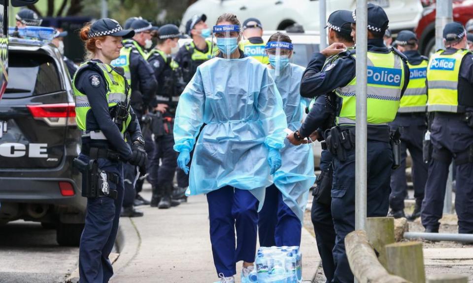 Medical staff surrounded by police