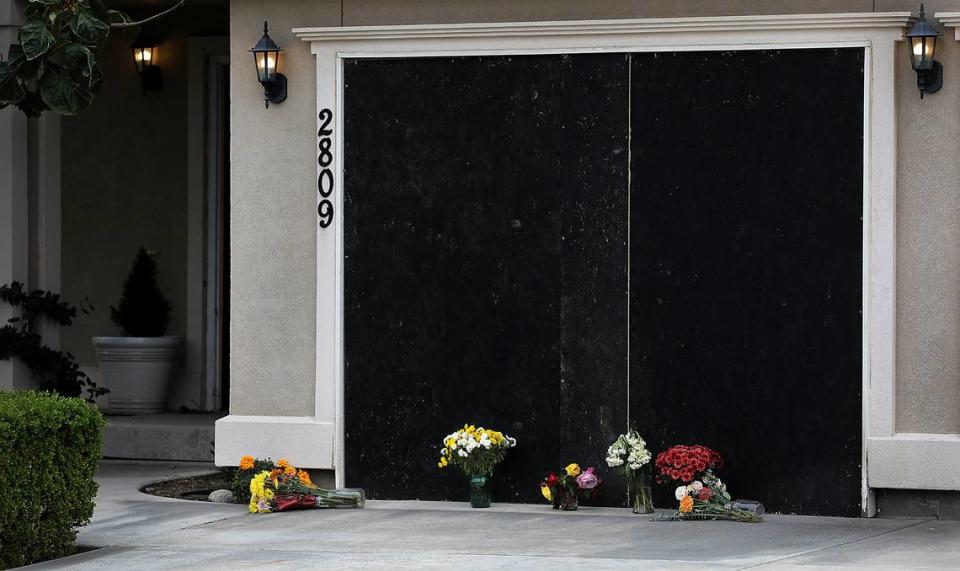 Vases of flowers were placed outside the Dawes Stree house where the bodies of Nabil Mohammed, 65 and his wife, Hifza Khan, 63, were discovered in October with his son Zuhaib Mohamed, 26.