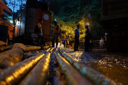 Rescue workers are seen in front of Tham Luang cave complex, as members of an under-16 soccer team and their coach have been found alive according to local media in the northern province of Chiang Rai, Thailand, July 5, 2018. REUTERS/Athit Perawongmetha