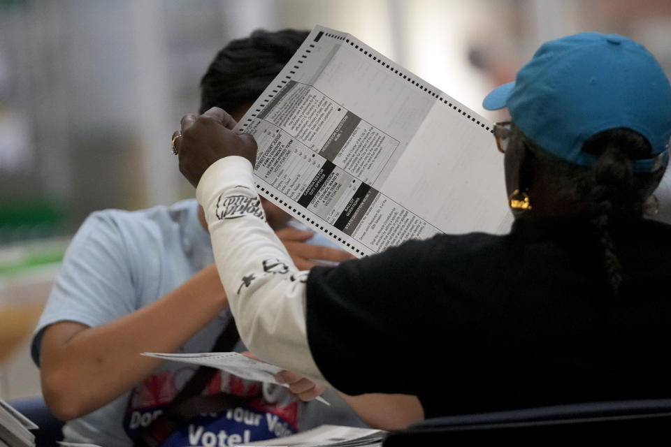 FILE - Election workers process ballots at the Clark County Election Department, Nov. 10, 2022, in Las Vegas. The Republican National Committee has filed voting-related lawsuits in two dozen states targeting such things as voter rolls, mailed balloting and policies related to poll watchers. Democrats say it’s a strategy designed to raise doubts about the legitimacy of the vote this fall and potentially delay certification of the results. (AP Photo/Gregory Bull, File)