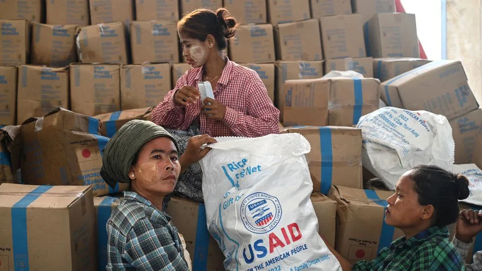 Workers sort through food at a damaged UN World Food Programme warehouse in Sittwe. - Sai Aung Main/AFP/Getty Images