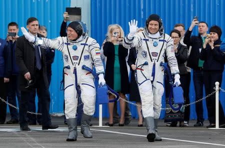 The International Space Station (ISS) crew members Jack Fischer of the U.S. (L) and Fyodor Yurchikhin of Russia walk after donning space suits shortly before their launch at the Baikonur cosmodrome, Kazakhstan April 20, 2017. REUTERS/Shamil Zhumatov