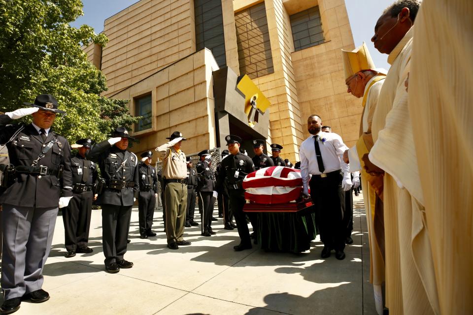 Pallbearers escort the casket out of the cathedral following a memorial service Los Angeles Police officer Juan Diaz at the Cathedral of Our Lady of the Angels in Los Angeles, Calif., on Aug. 12, 2019. (Al Seib/Los Angeles Times via AP)