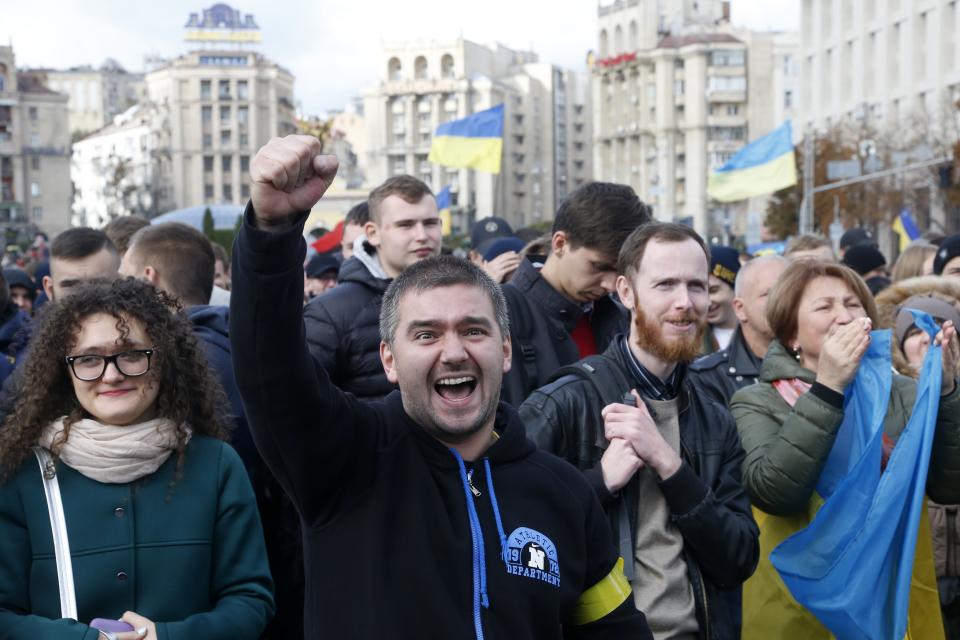 Protesters react as they listen to a speaker during a rally in Independence Square in Kyiv, Ukraine, Sunday, Oct. 6, 2019. Thousands are rallying in the Ukrainian capital against the president's plan to hold a local election in the country's rebel-held east, a move seen by some as a concession to Russia. (AP Photo/Efrem Lukatsky)