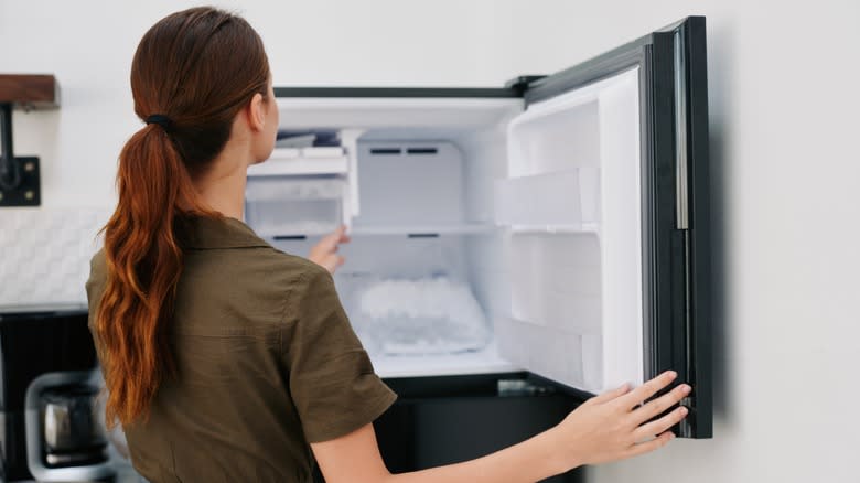 woman opening black freezer