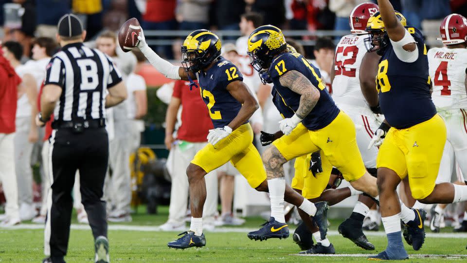 Michigan's Josh Wallace, No. 12, leaves the field after recovering a fumble in the fourth quarter Monday evening. - Kevork Djansezian/Getty Images