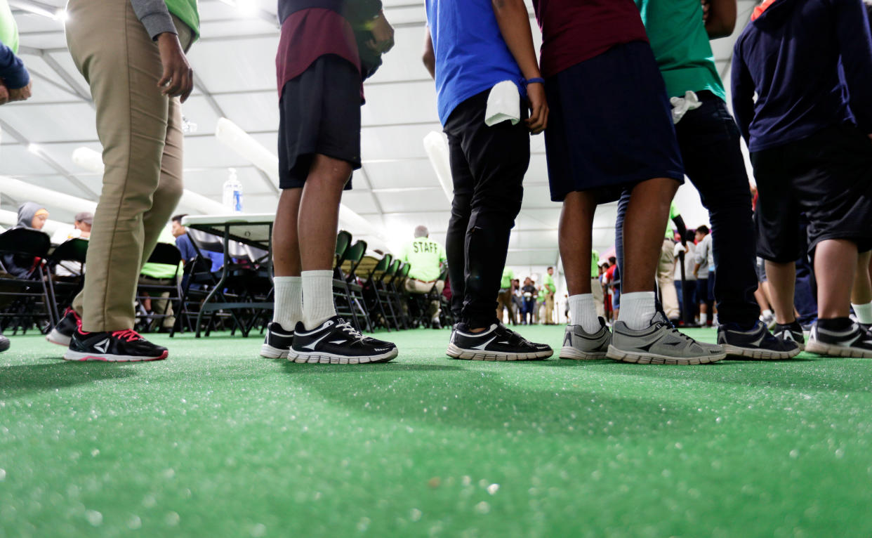 Migrants line up in the dining hall at the U.S. government's newest holding center for migrant children in Carrizo Springs, Texas, on July 9. (Photo: POOL New / Reuters)