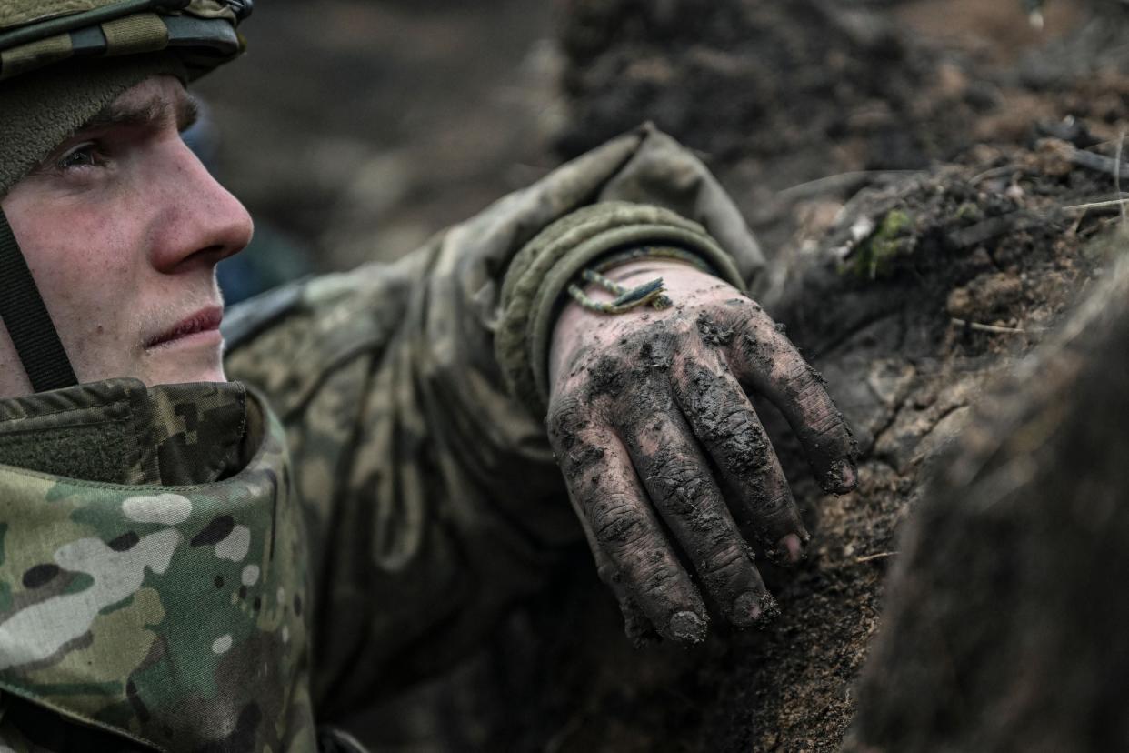 A Ukrainian serviceman looks on during shelling next to a 105mm howitzer near the city of Bakhmut (AFP via Getty Images)