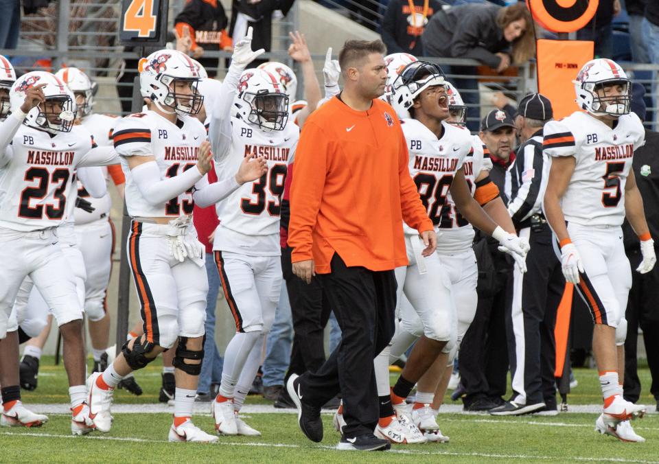 Massillon’s head coach Nate Moore leads the team out onto the field following their defeat of McKinley at Tom Benson Stadium on Saturday, Oct.23, 2021 