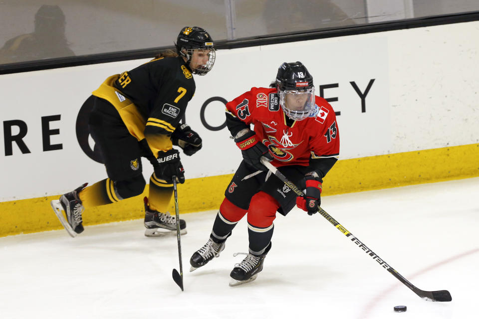 FILE - Toronto Six forward Mikyla Grant-Mentis (13) looks to pass the puck as Boston Pride forward Mary Parker (7) defends during the first period of a semifinal in the NWHL Isobel Cup hockey tournament March 26, 2021, in Boston. Grant-Mentis signed a one-year, $80,000 contract with Buffalo Beauts in May. The seven-team PHF opens its eighth season with six games Saturday, Nov. 5, including Buffalo hosting the expansion Montreal Force. (AP Photo/Mary Schwalm, File)