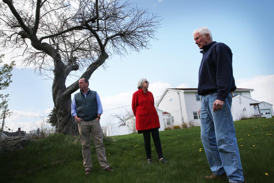 New Castle Select Board members Bill Stewart, left,  Jane Finn and Dave McGuckin are seen at the one-acre portion of the Coast Guard property they are proposing the town purchase for $5 million, plus legal fees.