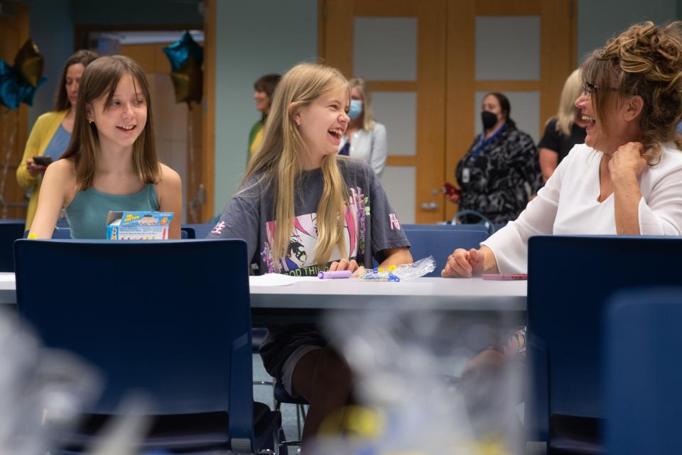 Smiles and laughter between Ukrainian families lighten the mood at Monday's Topeka USD 501 orientation event. The students had the chance to engage with school staff while getting information for enrolling in classes this coming school year.