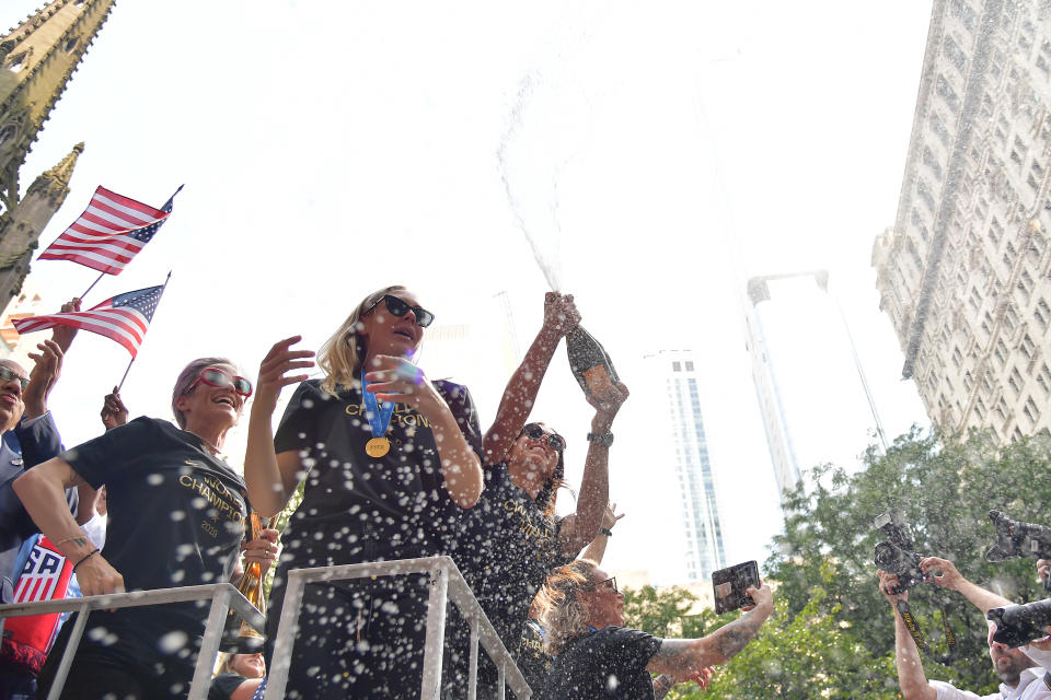 (L-R) Megan Rapinoe, Allie Long and Alex Morgan celebrate while riding on a float during The U.S. Women's National Soccer Team Victory Parade and City Hall Ceremony down the Canyon of Heroes on July 10, 2019 in New York City. (Photo by Michael Loccisano/Getty Images)