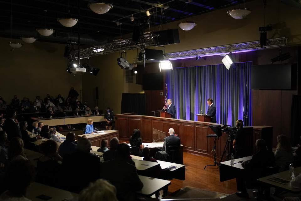 Democratic gubernatorial candidate and former governor Terry McAuliffe, back center, gestures as his Republican challenger, Glenn Youngkin, back right, looks on during a debate at the Appalachian School of Law in Grundy, Va., Thursday, Sept. 16, 2021. (AP Photo/Steve Helber)