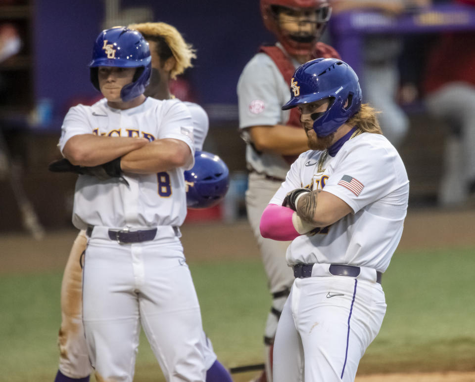 LSU's Tommy White, right, poses for teammates after hitting a three-run home run in the bottom of the third inning of an NCAA college baseball game against Alabama, Saturday, April 29, 2023, in Baton Rouge, La. (Michael Johnson/The Advocate via AP)