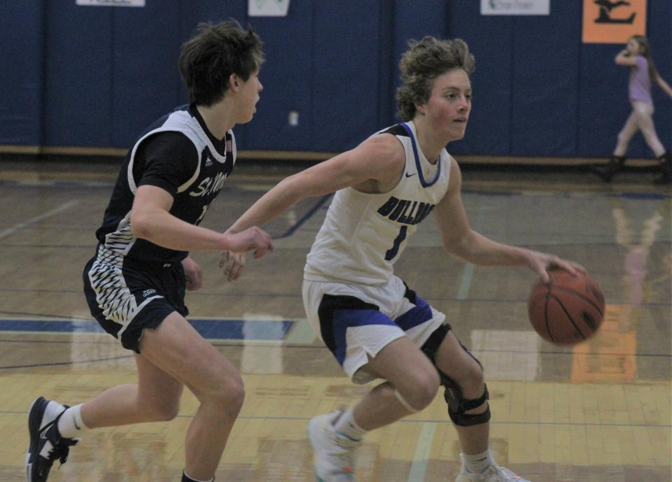 Inland Lakes junior guard Connor Wallace (right) attempts to get past Gaylord St. Mary's Daniel Jacobson during the first half of Tuesday night's boys basketball contest in Indian River.