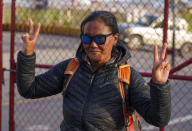 Nepalese climber Lhakpa Sherpa gestures as she arrives at the airport in Kathmandu, Nepal, Tuesday, May 17, 2022. The Nepali Sherpa broke her own record reaching the 8,849-meter (29,032-foot) summit for a 10th time — the most times any woman has climbed Mount Everest. Sherpa, 48, said she is next planning to scale the world's second-highest peak, K2 in Pakistan. (AP Photo/Niranjan Shrestha)