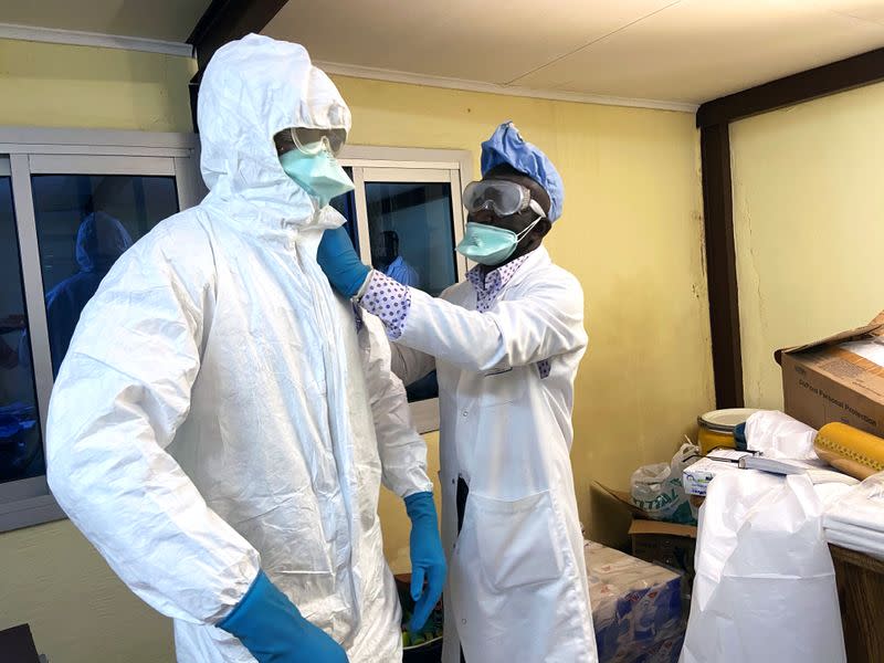 A medical staff wears protective gear at a new section specialised in receiving any person who may have been infected with coronavirus at The Quinquinie Hospital in Douala,