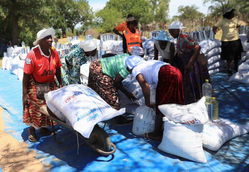 Villagers collect monthly allocations of food aid provided by WFP in Mumijo