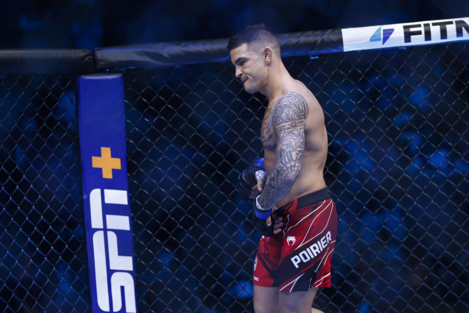Dustin Poirier enters the octagon before a lightweight mixed martial arts title bout against Charles Oliveira at UFC 269, Saturday, Dec. 11, 2021, in Las Vegas. (AP Photo/Chase Stevens)