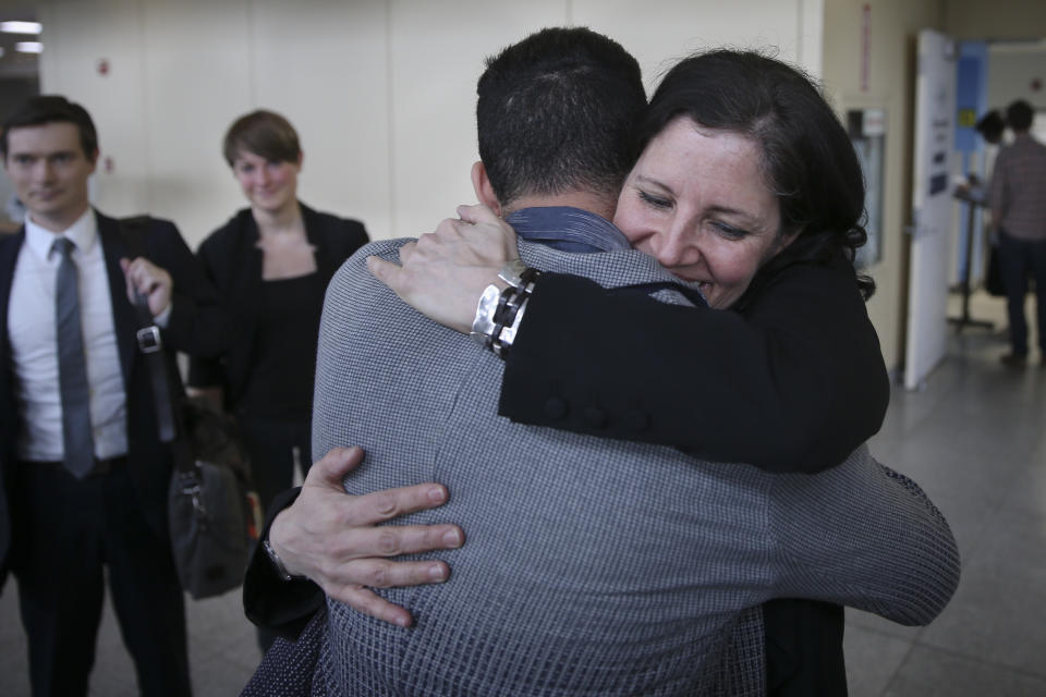 Laura Poitras, right, hugs David Michael Miranda after arriving at John F. Kennedy International Airport on Friday, April 11, 2014 in New York. Poitras and Glenn Greenwald share a George Polk Award for national security reporting with The Guardian's Ewen MacAskill and Barton Gellman, who has led The Washington Post's reporting on the NSA documents. (AP Photo/John Minchillo)