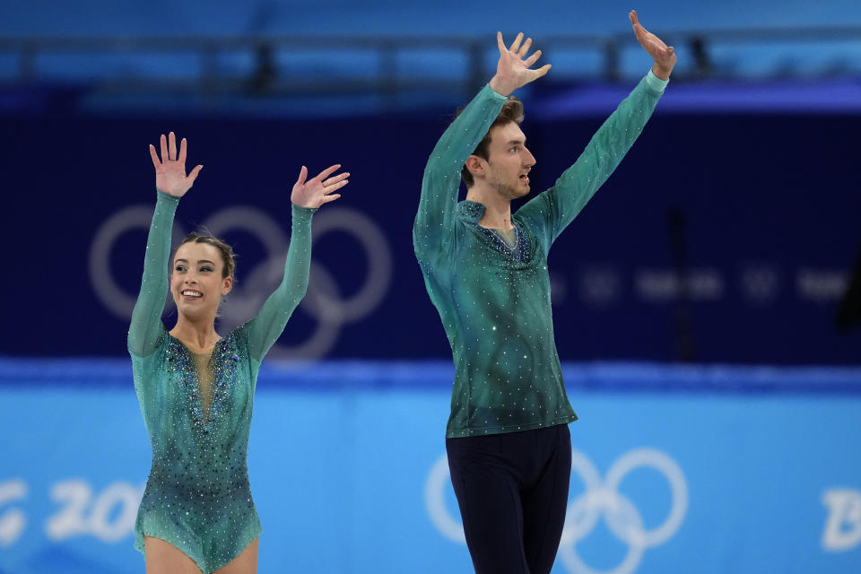 Laura Barquero and Marco Zandron, of Spain, wave after competing in the pairs free skate program during the figure skating competition at the 2022 Winter Olympics, Saturday, Feb. 19, 2022, in Beijing. (AP Photo/Natacha Pisarenko)